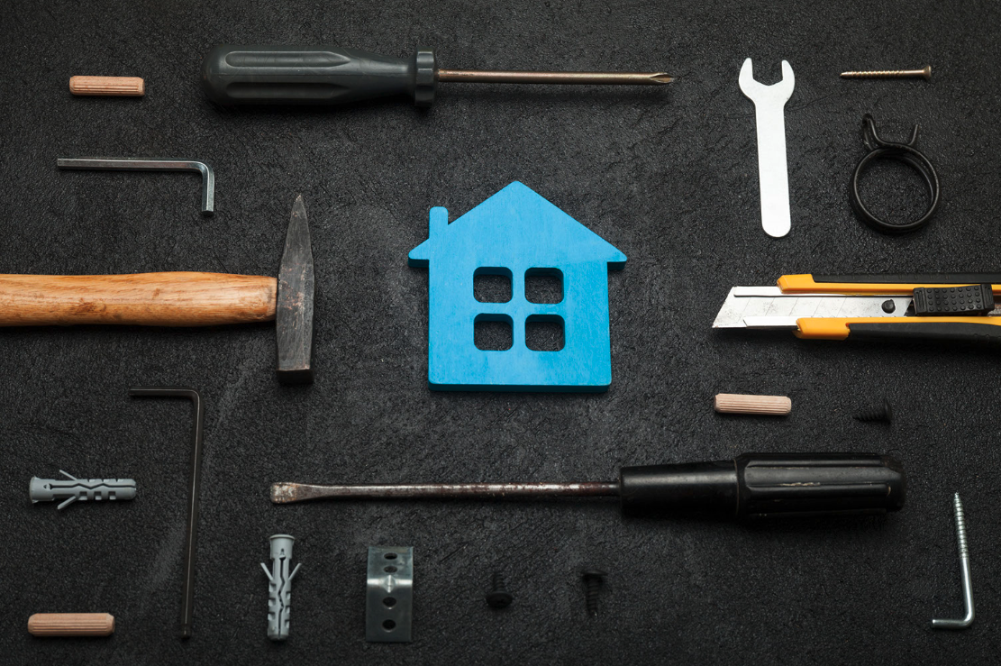 A decorative image showing various tools that you might use to repair a house. The tools include screwdrivers, wrenches, nails, hammers, bolts, and more.