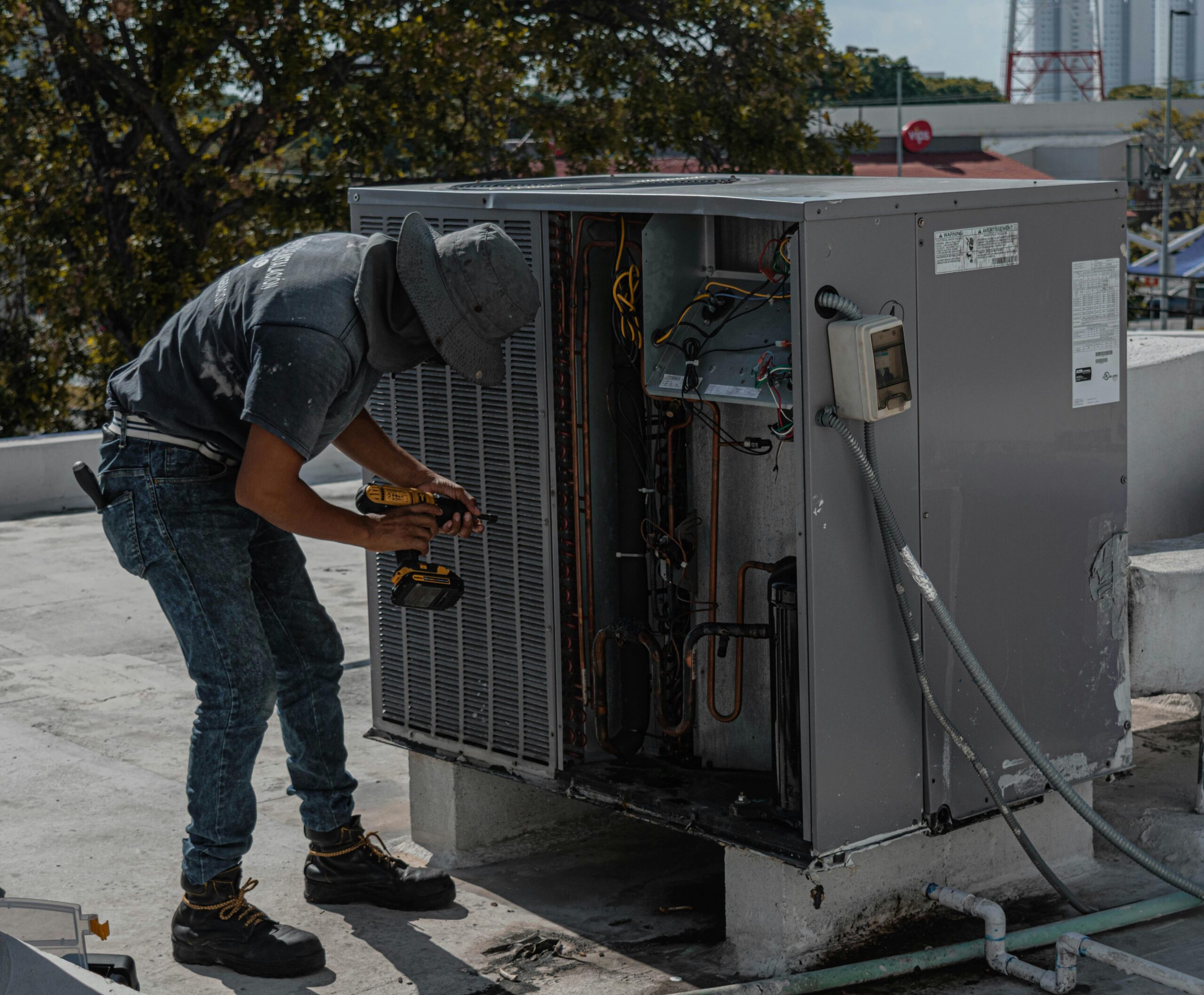 HVAC heating and cooling technician working on HVAC unit