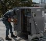 HVAC heating and cooling technician working on HVAC unit