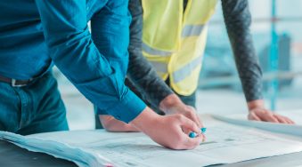 workers-checking-out-architectural-plan-project